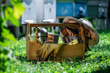 A tool of the beekeeper. Everything for a beekeeper to work with bees. Smoker, a chisel, a box, beekeeper suit for protection from the bees. Beekeeping equipment. Beekeeping concept.の写真素材