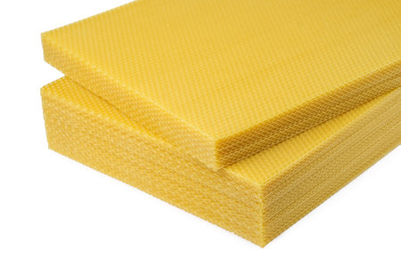 Beeswax. Wax base for honey bee rebuilding on a white background. Honeycombs.の写真素材