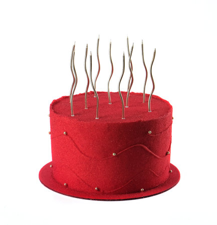 Red festive birthday cake with candles isolated on red background.の写真素材