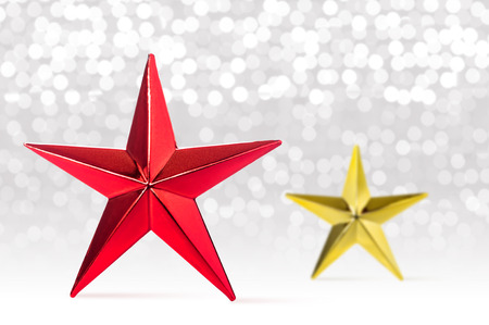 Christmas background. Red and golden star with lights snow winter background.
