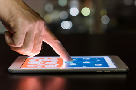 Closeup of finger touching screen on tablet with network connection. Selective focus.