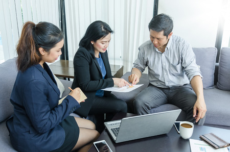 Success business team concept. Group of asian peoples dicussing something while working in office.の写真素材