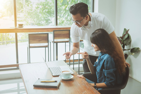 Business online concept. Asian friends meeting, drinking and having fun at coffee shop.の写真素材
