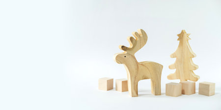 Christmas winter festive ornament. Wooden reindeer, pine tree and gift boxes decoration on white background. Christmas holiday party decoration. Minimal holiday greeting season.の写真素材