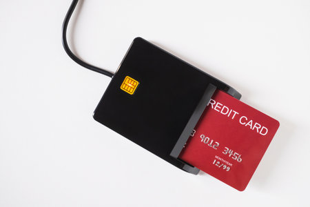 Swiping red credit card through payment terminal. Cashless technology and credit card payment...