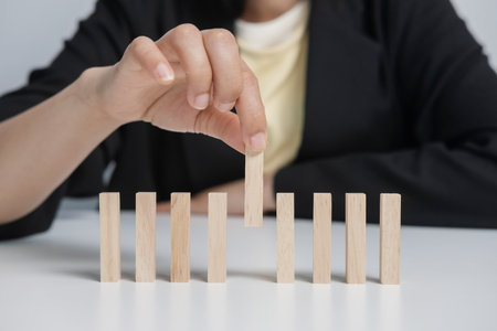 A businesswoman picks a wooden stick from the group. Successful business team leader. Leadership...