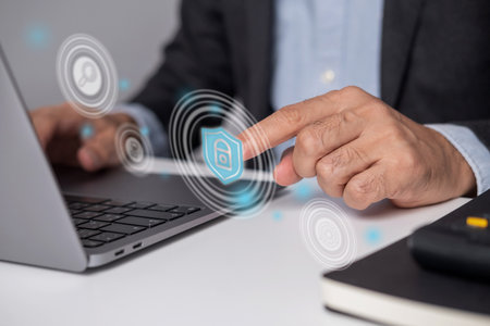 Close-up of businessman's hand touching virtual security application, Internet of Things and...