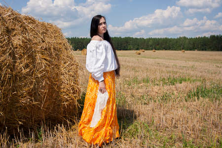 girl in a wheat field with a spikeletの写真素材