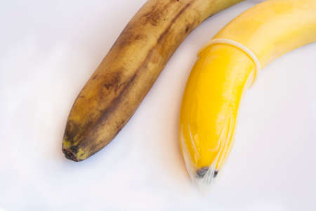 Condom and two bananas, venereal disease prevention concept.の写真素材