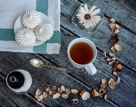 Nice food photo with a cup of tea and meringueの写真素材