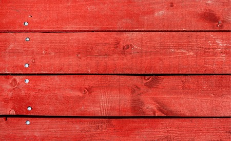 Background of wooden planks painted in red. Texture of wooden wallの写真素材
