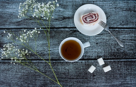 Still life shows tea, sweets and flowersの写真素材