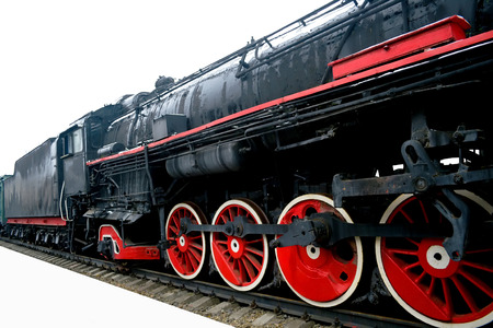 Old black locomotive on an isolated white background mounted on railsの写真素材