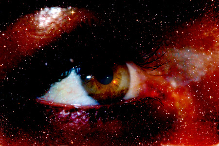 A photograph with a double exposure, the eye of the depths of the galaxy into the infinite space of the cosmos. People dream of future interstellar flightsの写真素材