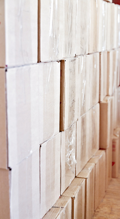 Boxes in a warehouse. The rows of boxes, stacked on one another. Storage room.の写真素材