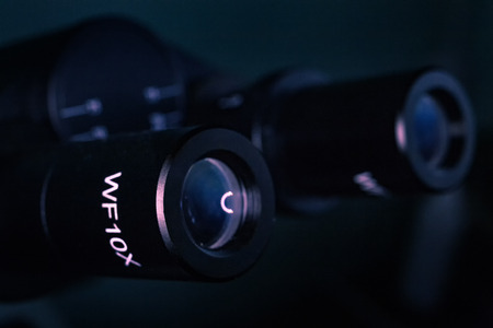 Microscope. The eyepiece of the microscope. Filmed in low key.の写真素材