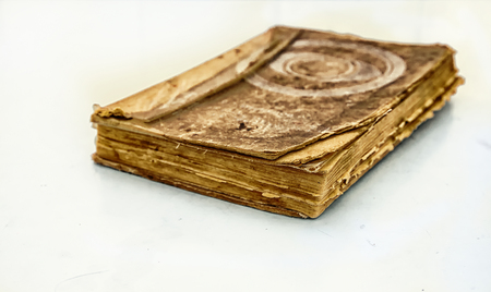 Old book. A battered Tome. Worn cover and yellowed pages. On a white background.の写真素材