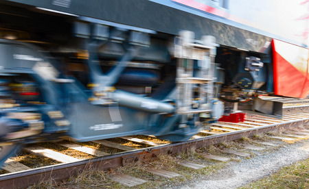 Train wheel. Fast movement of train wheels on rails. The path along the railway. The red color is very dangerous. The picture was taken with motion blur. Dynamic movement of the wheels.の写真素材