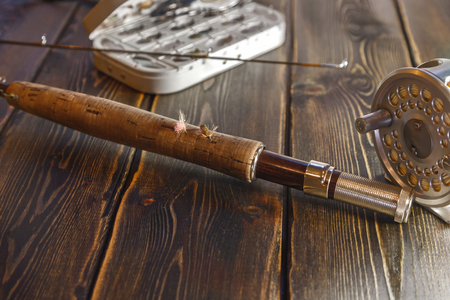 To fly fishing. Fishing rods for fishing on the river. The coil is made of aluminum with a yellow cord. Flies of feathers and fur. Box flies. Fit tackle to fly fishing. Tackle for salmon and grayling.の写真素材