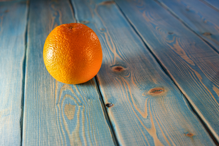 Orange. Citrus is on the table. Blue painted boards on the table. On the boards is red orange. Ripe fruit. Round edible fruit on blue boards.の写真素材