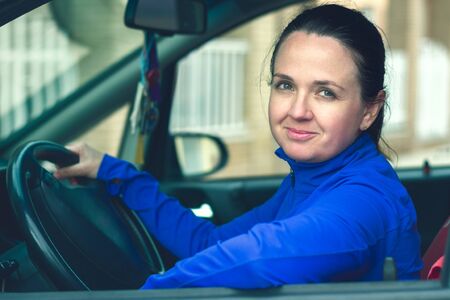 young woman in carの写真素材