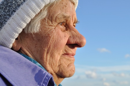 Portrait of an elderly woman, lost in thought, looks into the distanceの写真素材