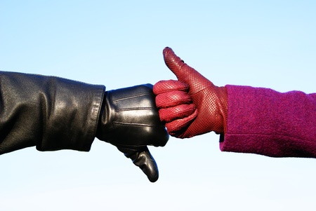 Men s and women s gloved hands, show life or death