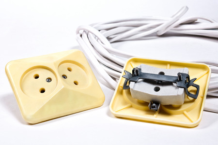 Wall sockets and power cable on white backgroundの写真素材