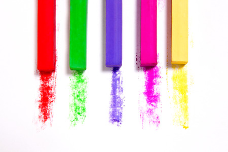Close up view of the colorful chalk pastels on the white background.の写真素材