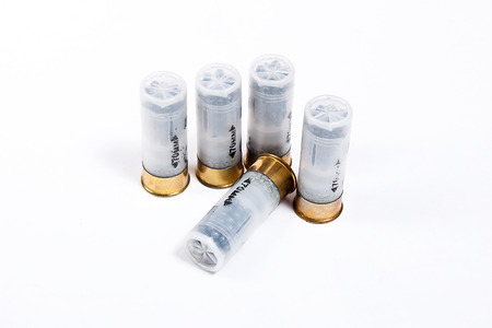 Four cartridges 12 caliber for hunting gun isolated on white.