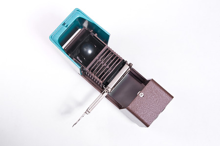 Retro cine-projector on the white background. Old projector for displaying of slides.