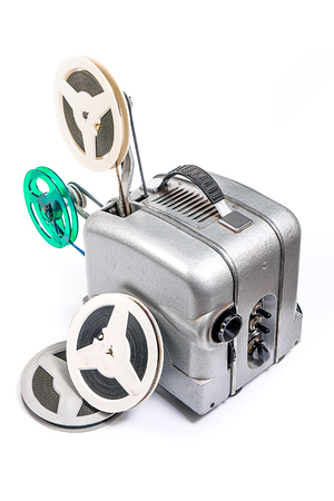 Retro old reel movie projector for cinema. A reels of motion picture film on a white background. Analogue movie projector with reels isolate on white background.の写真素材