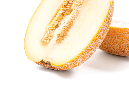 Half ripe juicy melon tropical fruit at summer time isolated on a white backgroundの写真素材
