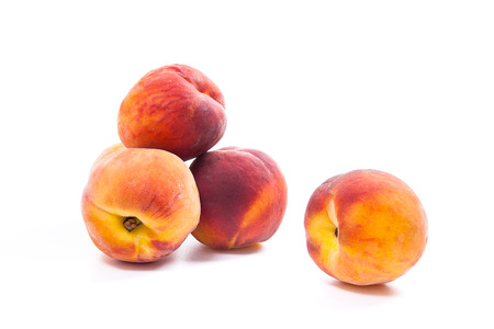 Several whole sweet juicy peach fruit  isolated on white backgroundの写真素材