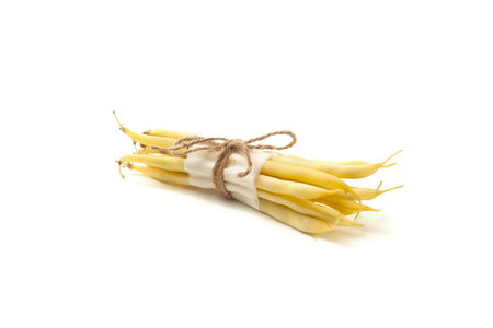 Bunch of raw yellow pods of haricot isolated on white background. French beans or Green beans also...