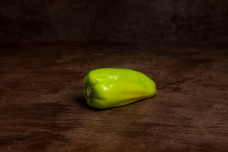 Green bell pepper (capsicum) known as sweet bell pepper, paprika on vintage wooden background. Vegetables collection.の写真素材
