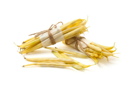 Two bunches and small pile of raw yellow pods of haricot isolated on white background. French beans or Green beans also known as String beans from India. Vegetables collection.の写真素材