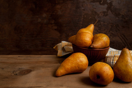Fruit background image. Ripe juicy pear fruits on vintage wooden background.の写真素材