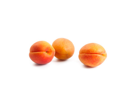 Several juicy ripe apricot fruits isolated on white background.の写真素材