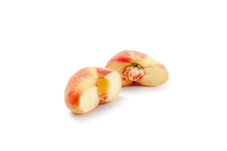 Half of ripe chinese flat peach fruits or saturn peach with soft shadow isolated on white background with clipping path.の写真素材
