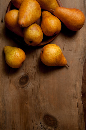 Fruit background image. Ripe juicy pear fruits on vintage wooden background.の写真素材