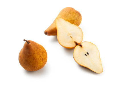 Two whole and halves of ripe juicy pear fruits with soft shadow isolated on white background with clipping path.の写真素材