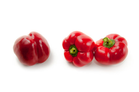 Three round red bell pepper (capsicum) known as sweet bell pepper, paprika isolated on white background with clipping path.の写真素材