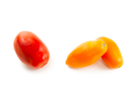 Assort of different shape and color of whole ripe juicy yellow tomatoes with soft shadow isolated on white background with clipping path. Vegetables collection on white.の写真素材