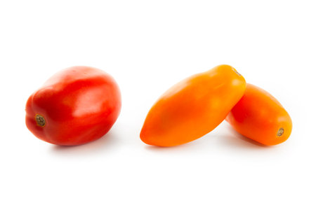 Assort of different shape and color of whole ripe juicy yellow tomatoes with soft shadow isolated on white background with clipping path. Vegetables collection on white.の写真素材