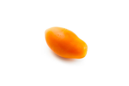 Whole ripe juicy yellow tomato with soft shadow isolated on white background with clipping path. Vegetables collection on white.の写真素材