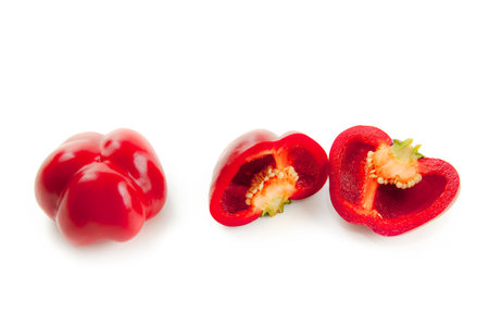 Whole and half of red bell pepper (capsicum) known as sweet bell pepper, paprika isolated on white background with clipping path.の写真素材