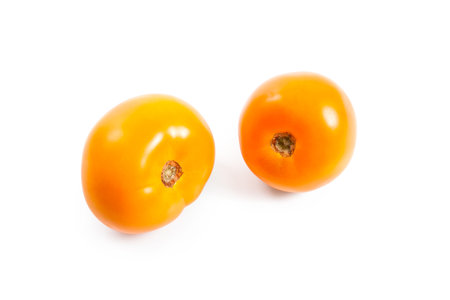 Whole ripe juicy yellow tomatoes with soft shadow isolated on white background. Vegetables collection on white.の写真素材