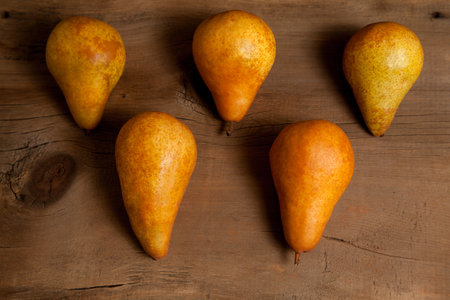 Several ripe juicy pear fruits on vintage wooden background.の写真素材