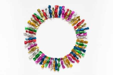 Candy colored wrappers on a white background.の写真素材